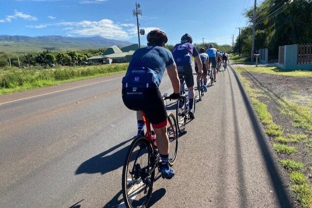 A group of people doing cycling on the road